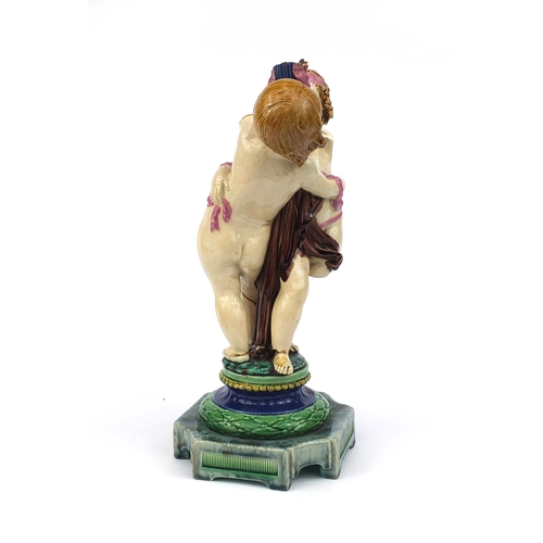 531 - Victorian Minton Majolica pottery candlestick modelled as a pair of  dancing putti with pink ribbons... 