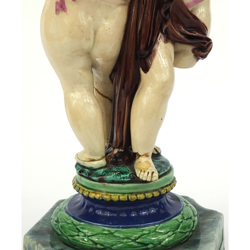 531 - Victorian Minton Majolica pottery candlestick modelled as a pair of  dancing putti with pink ribbons... 