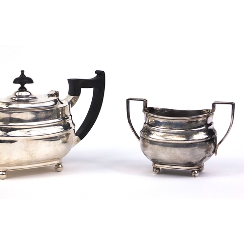 659 - Silver three piece tea service, the teapot with ebonised wood handle and knop, indistinct makers mar... 