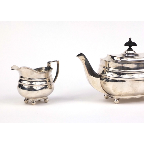 659 - Silver three piece tea service, the teapot with ebonised wood handle and knop, indistinct makers mar... 