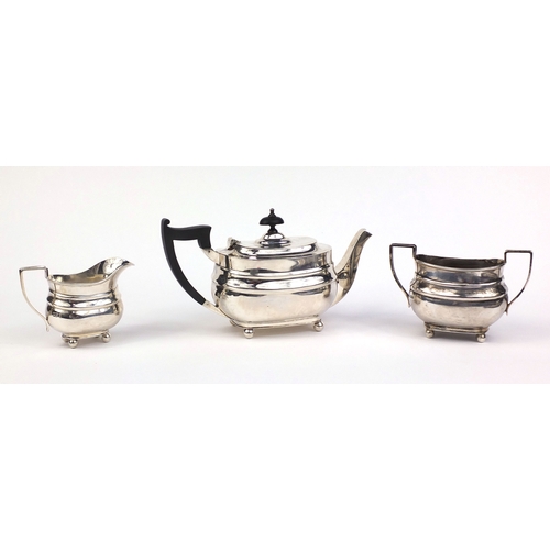 659 - Silver three piece tea service, the teapot with ebonised wood handle and knop, indistinct makers mar... 