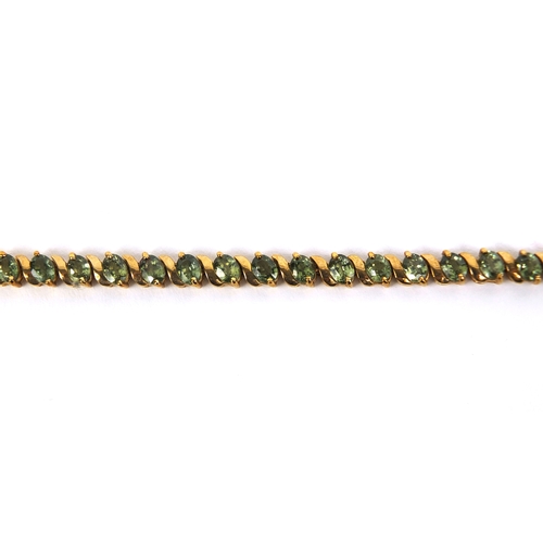 825 - 9ct gold peridot bracelet set with thirty four stones, 17cm long, approximate weight 9.8g