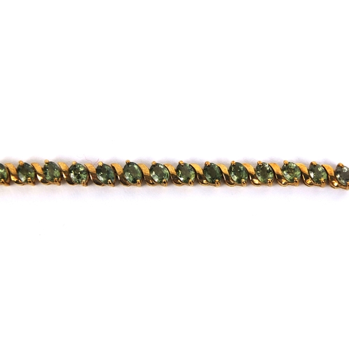 825 - 9ct gold peridot bracelet set with thirty four stones, 17cm long, approximate weight 9.8g