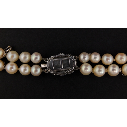 758 - Two row pearl necklace on a diamond clasp, set with ten solitaire diamonds, 40cm long, approximate w... 