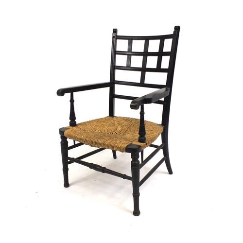 2025 - William Morris ebonised elbow chair with rush seat, 95cm high