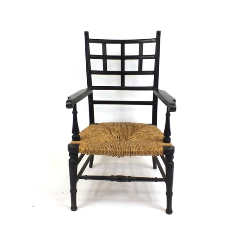 2025 - William Morris ebonised elbow chair with rush seat, 95cm high