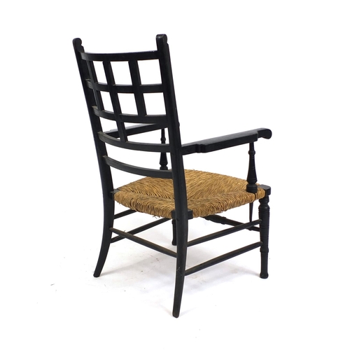 2025 - William Morris ebonised elbow chair with rush seat, 95cm high