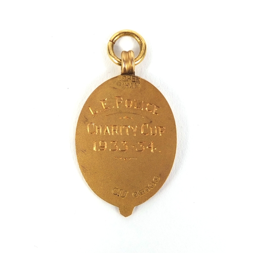 129 - 9ct gold 1933-34 L.E.Police charity cup sports jewel, 3.2cm high, approximate weight 3.2g