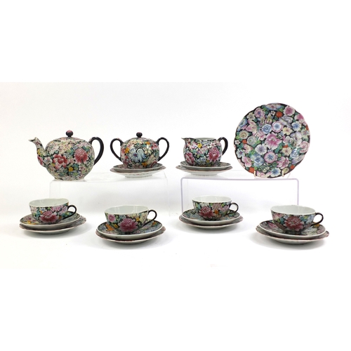 373 - Chinese porcelain part tea service, hand painted in the famille noire palette with flowers onto a bl... 