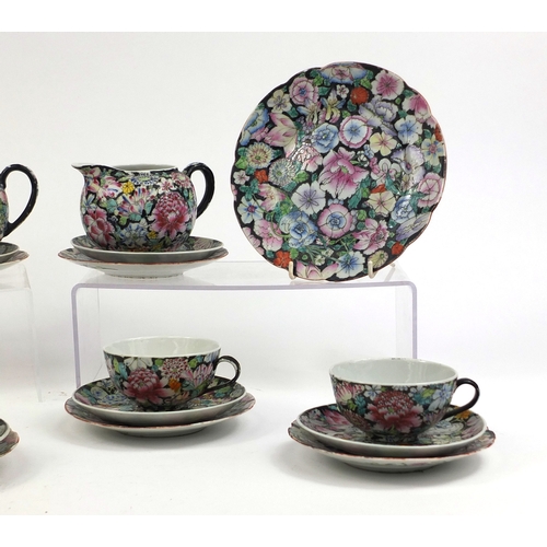 373 - Chinese porcelain part tea service, hand painted in the famille noire palette with flowers onto a bl... 