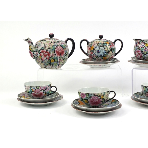 373 - Chinese porcelain part tea service, hand painted in the famille noire palette with flowers onto a bl... 