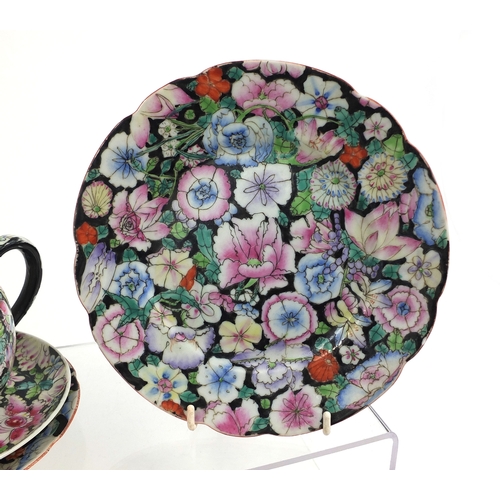 373 - Chinese porcelain part tea service, hand painted in the famille noire palette with flowers onto a bl... 