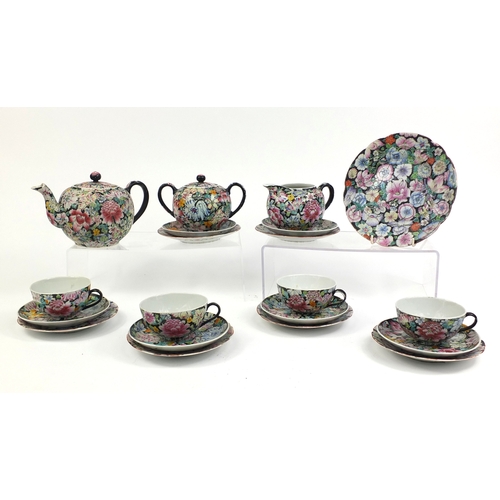 373 - Chinese porcelain part tea service, hand painted in the famille noire palette with flowers onto a bl... 