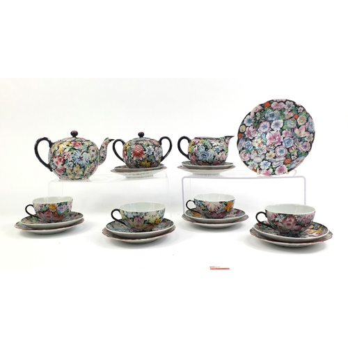 373 - Chinese porcelain part tea service, hand painted in the famille noire palette with flowers onto a bl... 