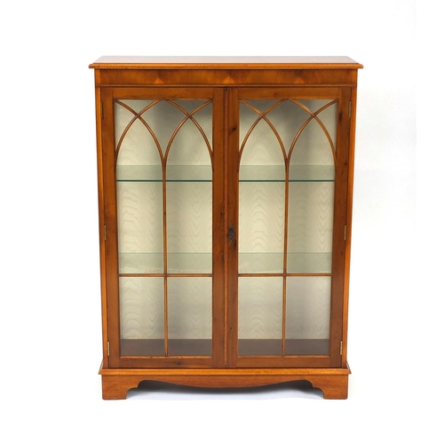 2026 - Yew bookcase with glazed doors, fitted with two glass shelves, 122cm high x 92cm wide x 32cm deep