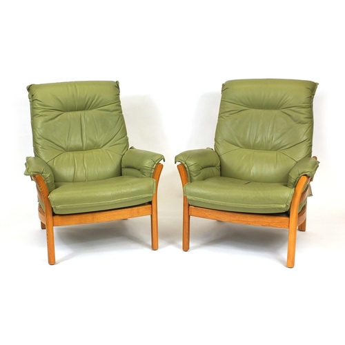 2009 - Ercol elm green leather upholstered seat comprising a three seater settee and two open armchairs, ea... 
