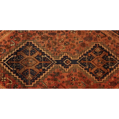 2055 - Rectangular Persian Shiraz rug, the central field having an all over stylised design within four geo... 