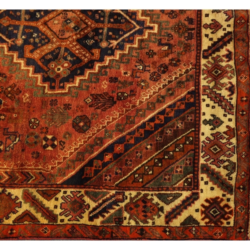 2055 - Rectangular Persian Shiraz rug, the central field having an all over stylised design within four geo... 