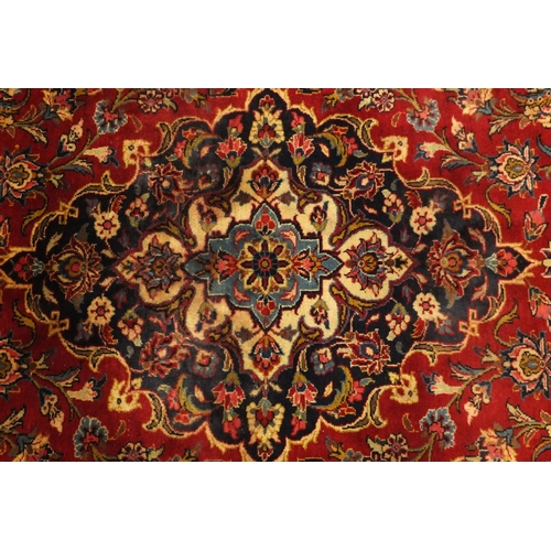 2003 - Rectangular Persian Meshed carpet, having an all over stylised floral design within foliate boarders... 