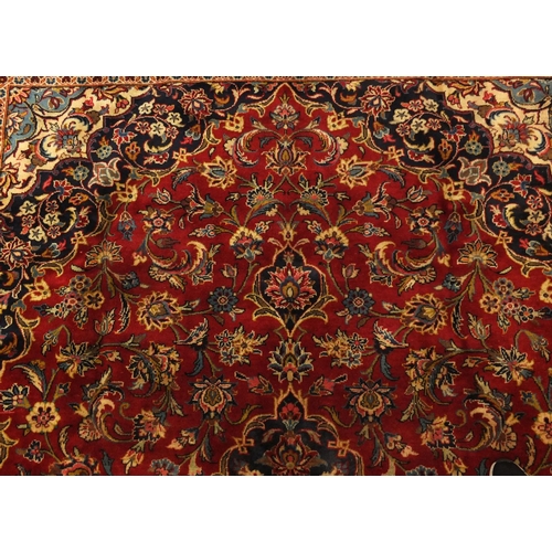 2003 - Rectangular Persian Meshed carpet, having an all over stylised floral design within foliate boarders... 