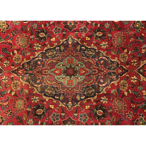 2020 - Rectangular Persian Meshed carpet, having an all over stylised floral design within foliate boarders... 