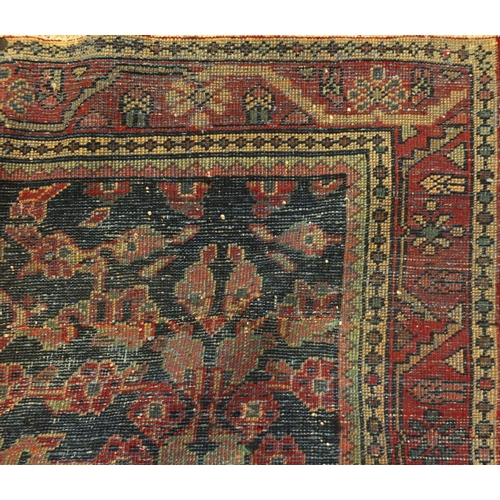 2024 - Rectangular Persian Mahal rug, the centeral field decorated with stylised motifs within foliate boar... 