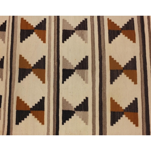 2043 - Rectangular Native American Navajo rug having an all over geometric design, 136cm x 70cm