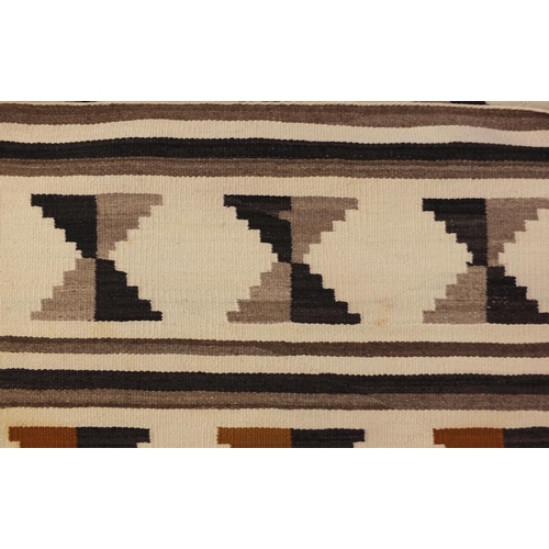 2043 - Rectangular Native American Navajo rug having an all over geometric design, 136cm x 70cm