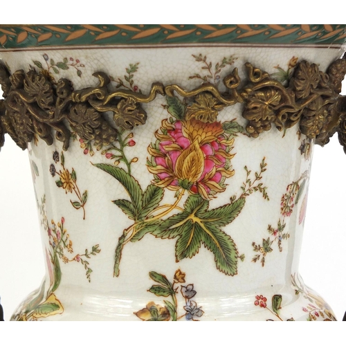 2127 - Twin handled urn shaped porcelain vase hand painted with flowers and foliage with stylised metal fit... 