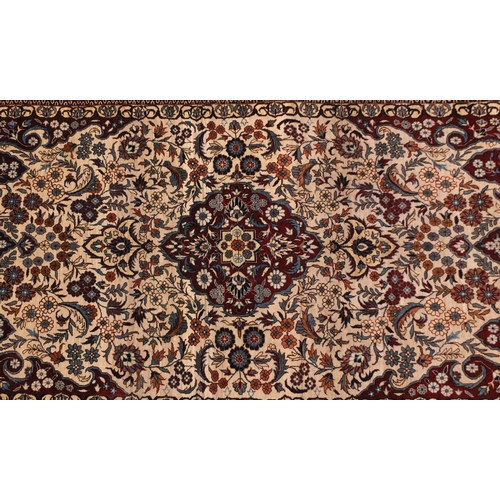2012 - Good quality rectangular Kashmir silk rug, having an all over stylised floral design within foliate ... 
