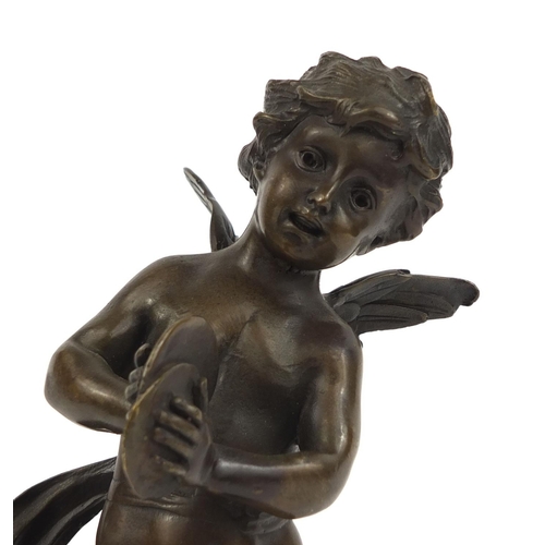 2208 - Bronze model of a fairy cupid raised on a faux marble base, 30c high