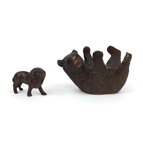 2380 - Black forest carved bear together with a bronze lion, the largest 14cm in length