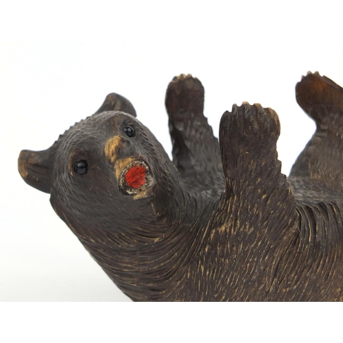 2380 - Black forest carved bear together with a bronze lion, the largest 14cm in length