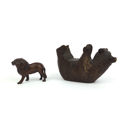 2380 - Black forest carved bear together with a bronze lion, the largest 14cm in length