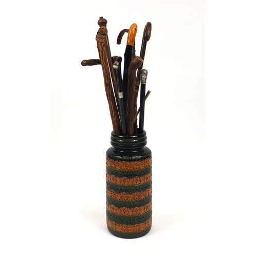 2061 - Ceramic stick stand marked West Germany and an assortment of walking sticks to include two with silv... 