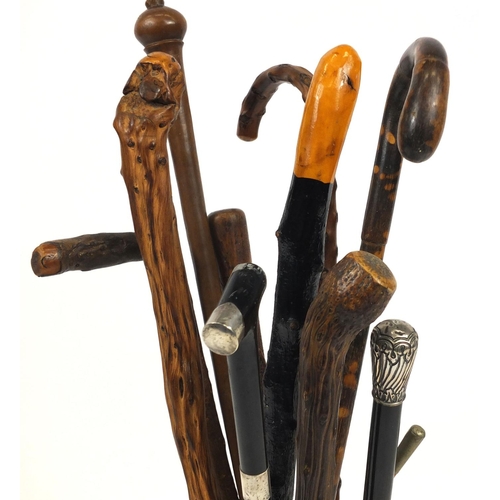 2061 - Ceramic stick stand marked West Germany and an assortment of walking sticks to include two with silv... 