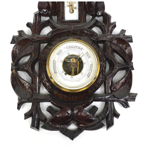 2255 - Black forest wall barometer thermometer carved with foliage, 47cm high