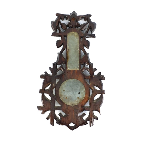 2255 - Black forest wall barometer thermometer carved with foliage, 47cm high