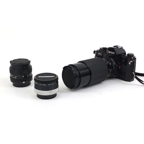 2209 - Canon A1 camera body together with three lenses comprising a HOYA HMC 58MM Skylight, a Tamron two x ... 