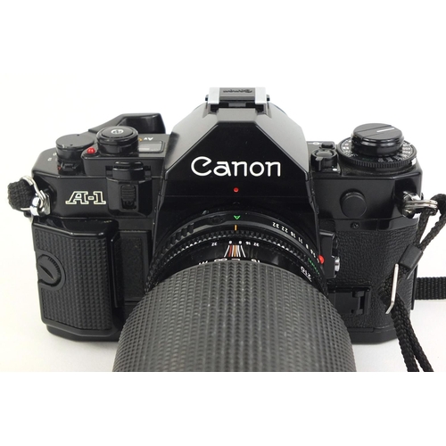 2209 - Canon A1 camera body together with three lenses comprising a HOYA HMC 58MM Skylight, a Tamron two x ... 