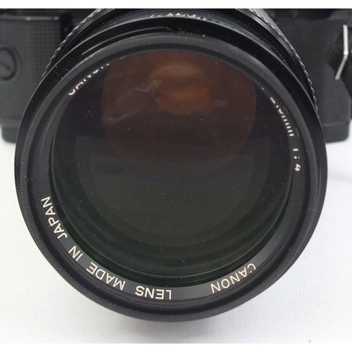 2209 - Canon A1 camera body together with three lenses comprising a HOYA HMC 58MM Skylight, a Tamron two x ... 