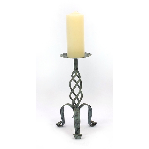 2310 - Wrought iron floor standing candle holder with hand decorated candle, 83cm high