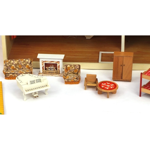 2349 - Swedish Lundby wooden and plastic dolls house with a large selection of boxed furniture, 88cm long