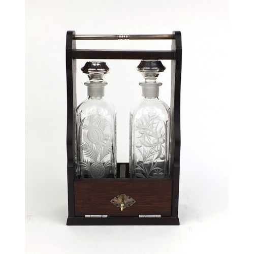 2130 - Two bottled Tantalus with silver stoppers and etched floral decoration, the stoppers hallmarked Birm... 