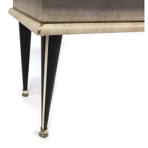 55 - Retro cream leatherette coffee table raised on tapering legs, 48cm high x 107cm wide x 41cm deep