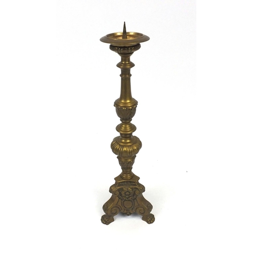 58 - Heavy brass floor standing candlestick with paw feet, 65cm high