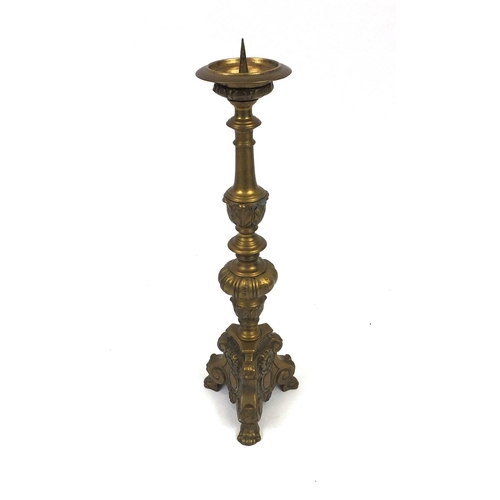 58 - Heavy brass floor standing candlestick with paw feet, 65cm high