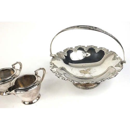 122 - T L & S silver plated three piece tea service, and a Hukin & Heath silver plated fruit basket with s... 