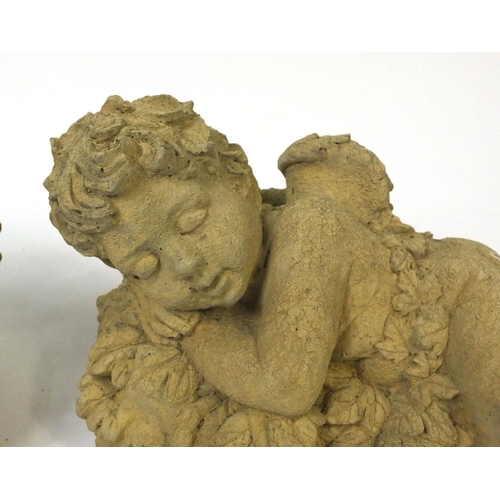 56 - Pair of garden stoneware cherubs, 32cm long