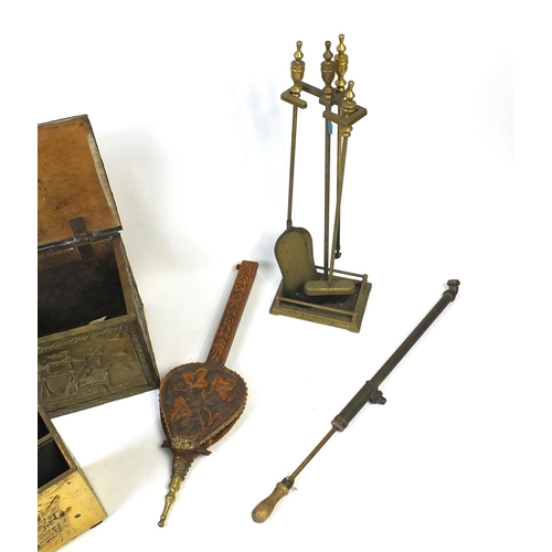 62 - Two brass mounted coal boxes, a similar magazine rack, brass companion set, fire bellows and a sprin... 